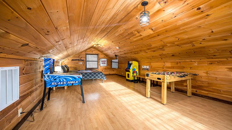 Upstairs gameroom with foosball, electronic pinball and Pac Man arcade machine.